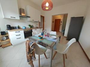 a kitchen with a table and chairs in a kitchen at La Casina in Cecina