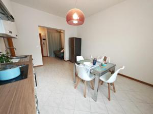 a kitchen and dining room with a table and chairs at La Casina in Cecina