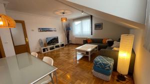 a living room with a couch and a table at El Fuerte vacaciones para 5 personas con garaje wifi y petfriendly in Ribadesella