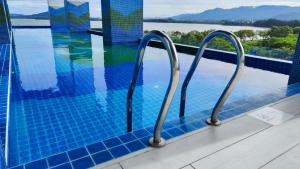 a swimming pool with a view of the water at Bay Win La,mer Butik in Kota Kinabalu