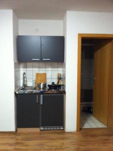 a kitchen with a sink and a counter top at Ferienidyll Zwiesel in Zwiesel +3 photos