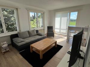 a living room with a couch and a table at Murten Moments in Murten