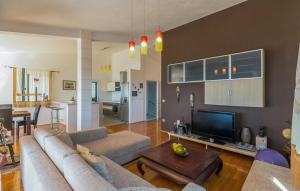 a living room with a couch and a tv and a table at Apartman Tara - Makarska by Villas Guide in Makar +9 photos