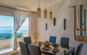 a dining room with a table and chairs and a window at Apartman Tara - Makarska by Villas Guide in Makar