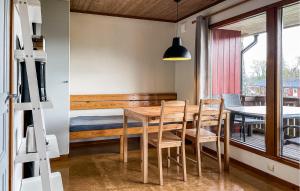 a dining room with a wooden table and chairs at 2 Bedroom Amazing Home In Degeberga in Degeberga