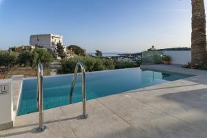 a swimming pool on the roof of a house at Aspras Luxury Apartments in Koutsounari