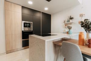 a kitchen with a counter with a microwave and a stove at Casa Madie in Orihuela Costa
