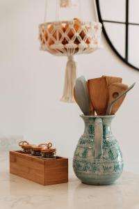 a vase with spoons in it sitting on a table at Casa Madie in Orihuela Costa