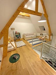 a living room with a loft with wooden beams at Grange Bernata, havre de paix sur la colline in Pontacq