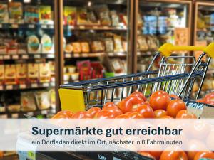 a shopping cart filled with tomatoes in a store at Peenemünde, Panoramawohnung in Peenemünde +15 photos