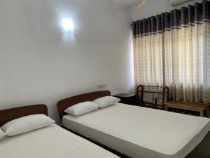 Postel nebo postele na pokoji v ubytování Hotel Ameliya
