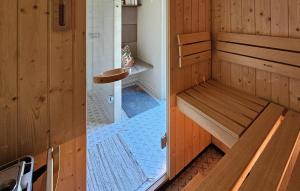 a small bathroom with a bench and a shower at Beautiful Home In Podwilczyn With Sauna in Dębnica Kaszubska +22 photos