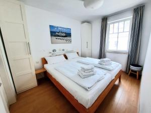 Ein Bett oder Betten in einem Zimmer der Unterkunft Villa Rosa - Apt. 15