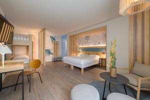 a bedroom with a bed and a living room at Ibis Styles Regensburg in Regensburg +171 photos