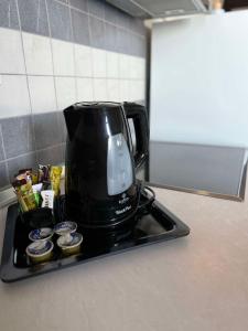 a black coffee pot on a tray on a kitchen counter at White Shark Villas in Litochoro +20 photos