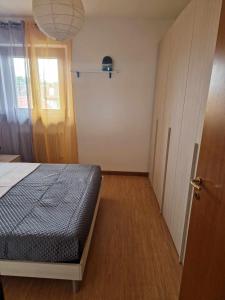a bedroom with a bed and a door with a window at Sara apartment in the heart of Udine Sud in Udine