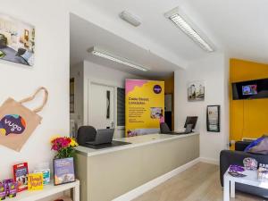 a store with a counter with two laptops on it at For Student Only - Cable Street 10 Min Walk to Lancaster Station in Lancaster