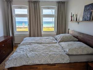 a bedroom with a bed with a view of the ocean at Haus am Meer- Traumhafter Meerblick in Dahme