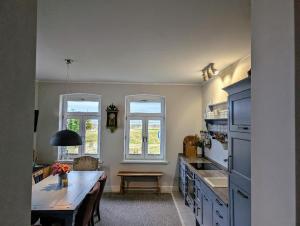 a kitchen with a table and a counter top at Haus am Meer- Traumhafter Meerblick in Dahme +9 photos