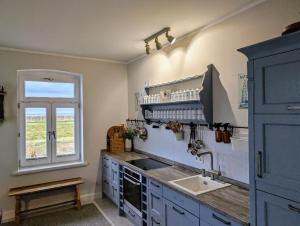 a kitchen with a sink and a window at Haus am Meer- Traumhafter Meerblick in Dahme