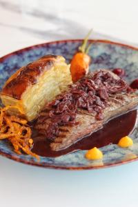 a plate of food with a piece of cake and fruit at Hôtel - Restaurant U Santu Petru in Saint-Florent