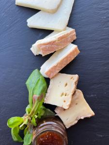 a group of different types of cheese on a table at Hôtel - Restaurant U Santu Petru in Saint-Florent