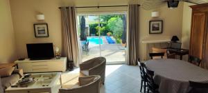 a living room with a couch and a table and a television at Maison de ville style échoppe in Le Bouscat