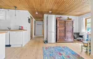 a kitchen with a refrigerator and a wooden door at 3 Bedroom Lovely Home In Nykøbing Sj in Klint