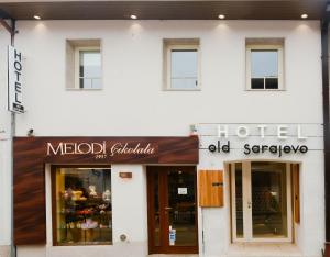 a white building with a medical clinic and an old dispensary at Hotel Old Sarajevo in Sarajevo