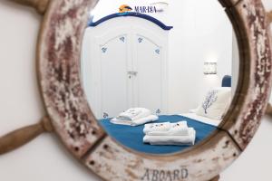 a mirror reflecting a room with towels on a bed at MAR-ISA Amalfi Coast - Luxury Suites & Apartments in Vietri sul Mare +231 photos