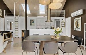 a kitchen and dining room with a table and chairs at Gorgeous Home In Brovst With Sauna in Brovst