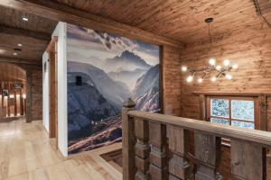 a large mural on the wall in a room with a staircase at Chalet LAUDEGG in Ladis