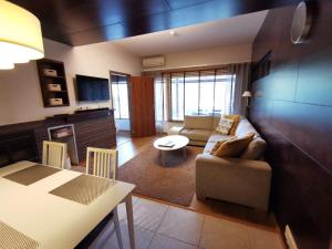 a living room with a couch and a table at Tahko Spa Suite B3 in Tahkovuori