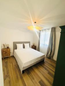 Ένα ή περισσότερα κρεβάτια σε δωμάτιο στο Les chambres du Cap Corse