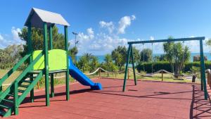 a playground with a slide and a slideintend at Rais Gerbi Appartamento in Pollina