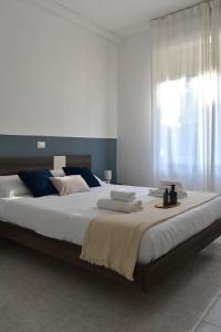 a bedroom with a large bed with towels on it at Poggio Al Lago Apartments & Rooms in Sirmione