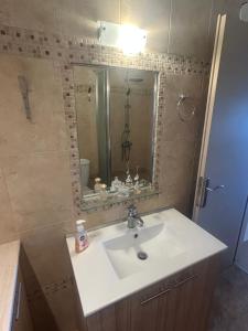 a bathroom with a sink and a mirror at Villa Anastasia in Leptokaria