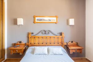 a bedroom with a bed and two nightstands and a mirror at Callejon Del Pozo in Gálvez +137 photos
