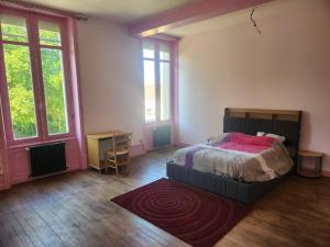 a bedroom with a bed and a rug on the floor at Manoir, vaste parc arboré in Montbron +55 photos