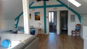 a living room with a couch and a bed at QUIET PLACE in Biscarrosse