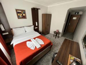 Postel nebo postele na pokoji v ubytování Hotel Topkapı