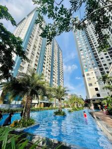 a swimming pool in the middle of two tall buildings at Charm Apartment in Dĩ An