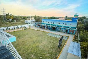 an aerial view of a building with a large yard at Hotel Pergola - Mysore in Chāmundi