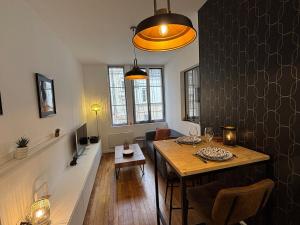 a living room with a dining room table and a dining roomiasm at Le Saint André Hyper centre ville in Saint-Quentin