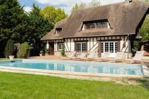 dom z basenem przed domem w obiekcie Superbe Maison Normande avec Piscine à 3 minutes de la mer w mieście Auberville