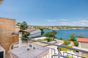 a balcony with a table and a view of the water at Studio apartment Karla with beautiful Sea view in Šilo