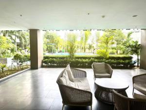 a patio with couches and chairs and a table at Urban Boho Oasis1 Studio With Balcony in Davao City