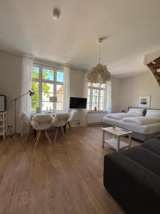 a large living room with a bed and a table at Hotel Zollhaus in Schleswig