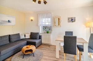a living room with a couch and a table at Ferienwohnung Lavendel Hofgeismar in Hofgeismar