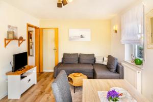 a living room with a couch and a table at Ferienwohnung Lavendel Hofgeismar in Hofgeismar
